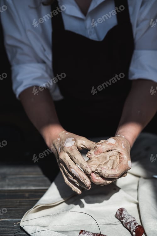 Preview: The potter's woman hands are shaping a cup from a clay. The process of creating pottery. The