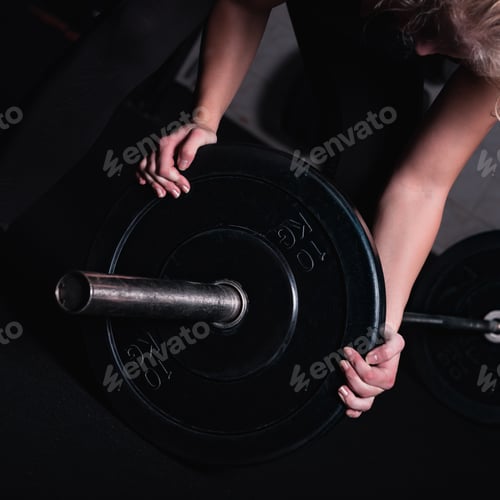 Preview: Sporty Woman With Barbell In A Gym