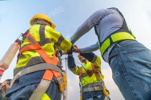 Preview: Engineer wearing uniform ,helmet show holding corporate work in wind turbine farms rotation to gener