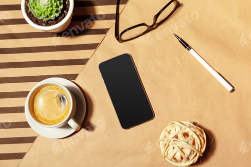 Preview: Cozy workspace with coffee, smartphone, and office supplies in natural light