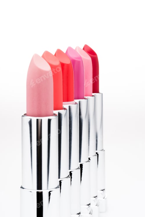Preview: Set of fashionable lipsticks of different colors in a row isolated on white