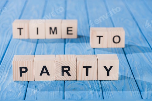 Visualização: visão aproximada de blocos de madeira dispostos na hora da frase de festa em superfície de madeira azul