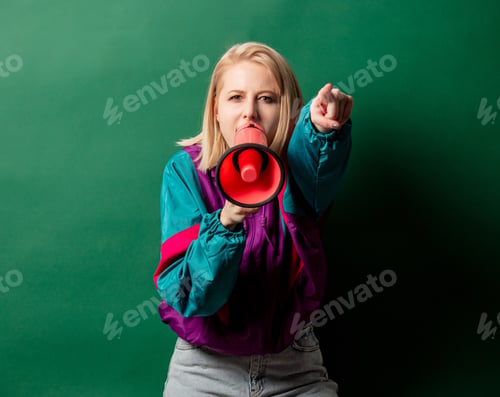 Preview: woman in 90s style punk jacket with loudspeaker on green background