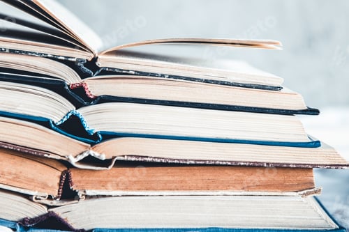 Preview: Opened books in a stack on a light home background. Education, hobbies