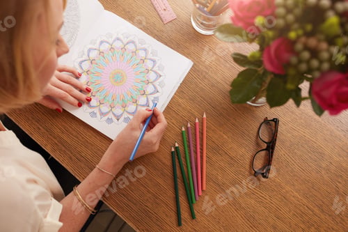Preview: Female drawing in adult coloring book at home