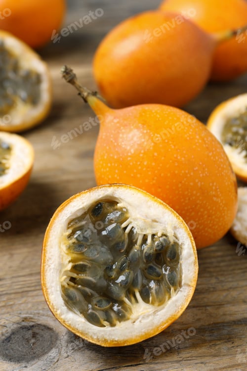 Preview: Delicious ripe granadillas on wooden table, closeup