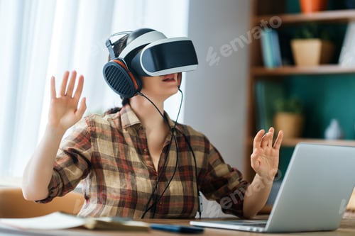 Preview: Woman Experiencing Virtual Reality with VR Headset and Laptop