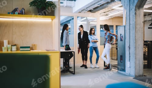 Preview: Positive colleagues communicating during break in office