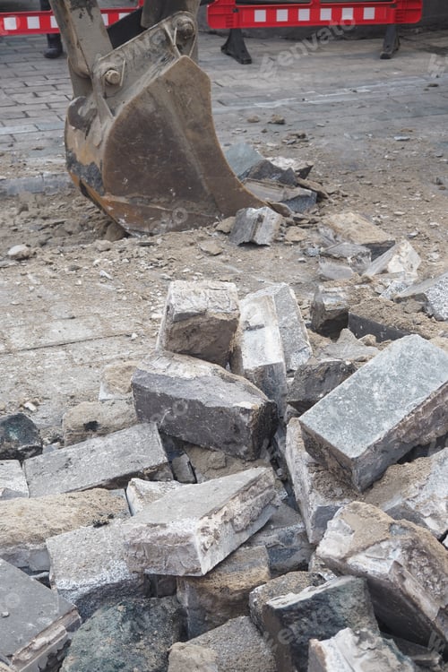 Preview: Heavy machinery is breaking up pavement in a construction site throughout the day