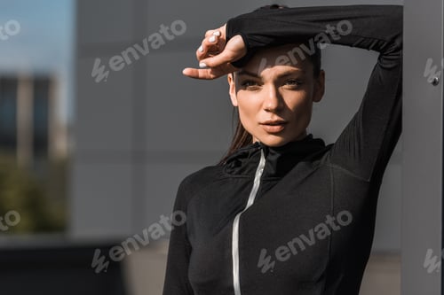 Preview: portrait of sportswoman posing in black thermal clothes