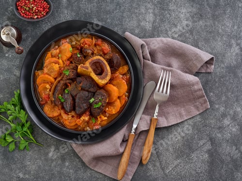 Preview: Ossobuco. Steak veal bake or stew with vegetable sauce and spices on an old concrete table