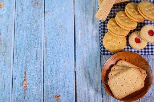 Preview: Stack many types of cookies on a plate and put on a wooden table.