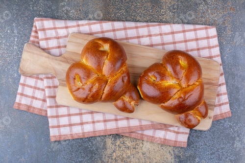 Preview: Two heart-shaped buns on a board on marble background