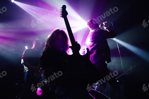 Preview: Rock band performing live music on stage with purple lighting