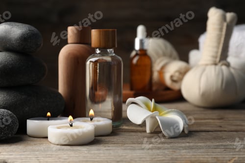 Preview: Composition with cosmetic products and spa stones on wooden table, closeup