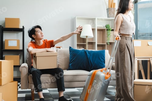 Preview: Unhappy young couple sitting apart, having problems in relationship
