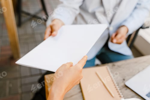 Preview: Young man and woman working with papers during business meeting