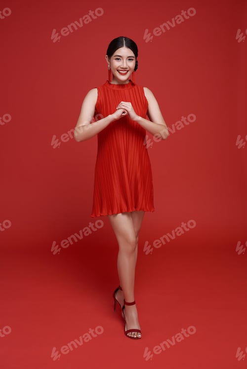 Preview: Happy Chinese new year. Asian woman wearing red dress with gesture of congratulation
