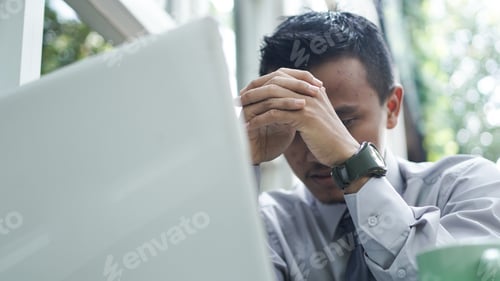 Preview: young entrepreneurs think while sitting down with laptop