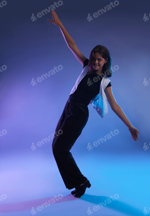 Preview: Teenage girl in tap shoes dancing on color background