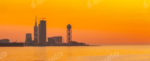 Preview: Batumi, Adjara, Georgia. Skyline Of Resort Town At Sunset Sunrise. Bright Orange Evening Sky. View