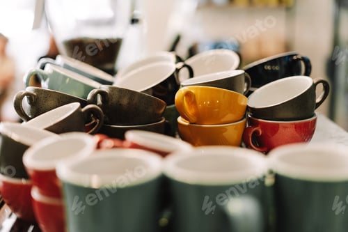 Preview: Many empty colorful coffee cups stacked in cafe