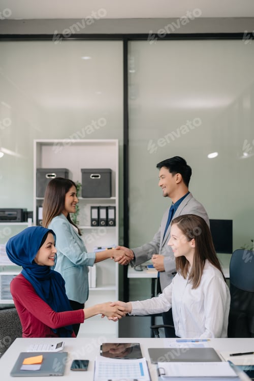 Preview: Business partnership handshake concept.Photo two coworkers handshaking process.