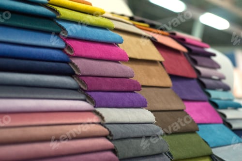 Preview: Stacks of colorful fabric textile samples in a shop