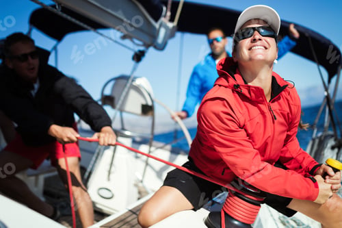 Preview: Attractive strong woman sailing with her boat
