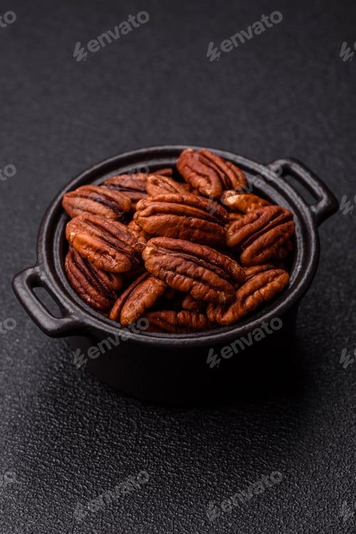 Preview: Peeled and roasted pecan nut as an ingredient for healthy food. Pecan nut as a food background