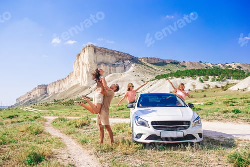 Preview: Happy family of four walking in the mountains