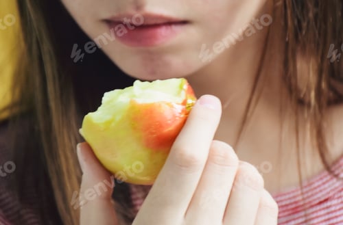 Preview: Young girl eating an apple