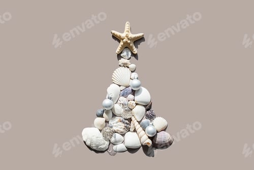 Preview: Christmas tree made of sea shells and starfish on beige background.