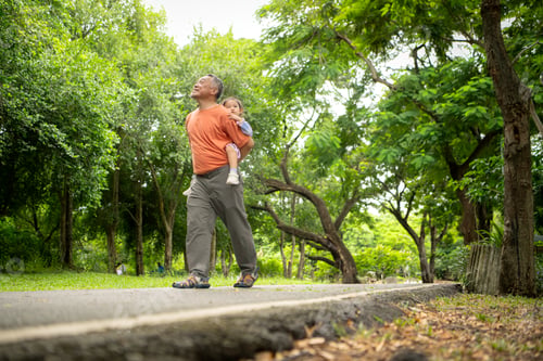 Preview: Grandfather and granddaughter jogging together in the park