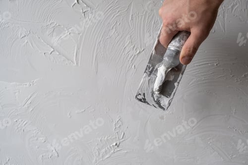Preview: Applying decorative putty. White abstract texture of surface covered with putty
