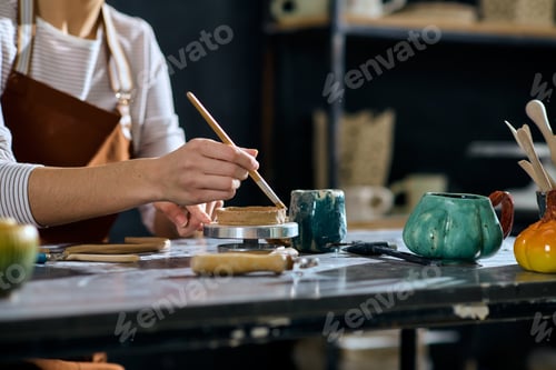Preview: Young woman creates exquisite pottery in a vibrant studio filled with artistic inspiration