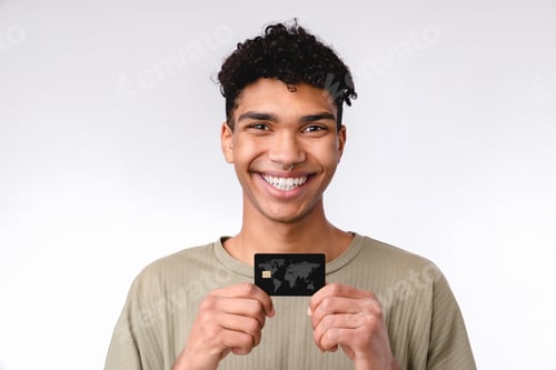 Preview: Smiling young african student showing credit card isolated over white background