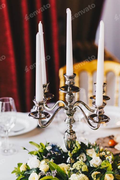 Preview: Luxurious banquet table served with beautiful candlestick with white candles, nice flowers