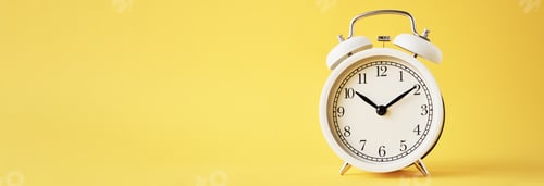 Preview: White vintage alarm clock on a yellow background, long banner with copy space
