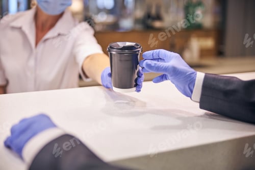 Preview: Man buying hot drink in cafe during quarantine