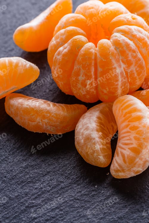 Preview: juicy mandarin on a dark stone background