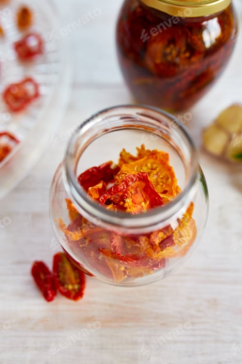 Preview: Homemade sun dried tomatoes with herbs, garlic in olive oil in a glass jar