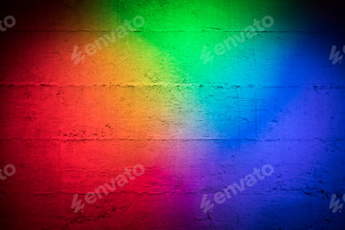 Preview: Coloured primary colored lights red blue and green on a textured concrete wall as background stage p