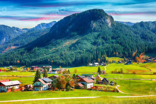 Preview: Alpine green fields and traditional wooden houses view of the Gosau village at autumn sunny day.