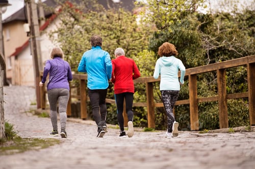Preview: Group of seniors running outdoors in the old town.