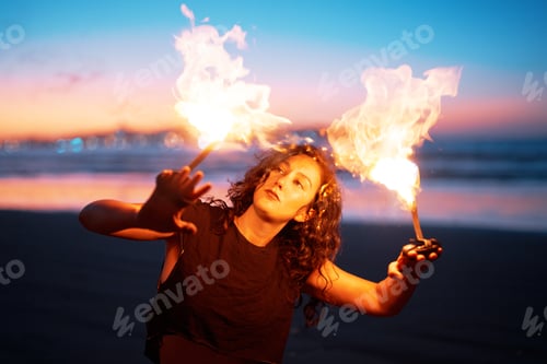 Preview: woman dancing with fire on the beach