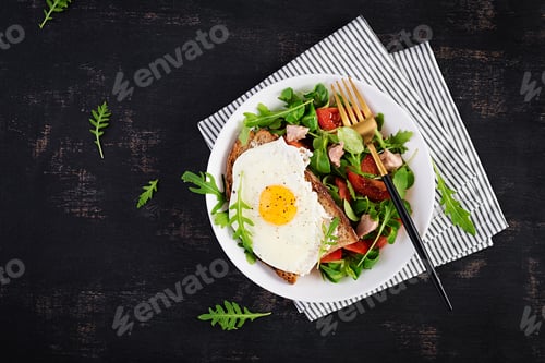 Preview: Breakfast - toast with fried eggs and tomatoes salad with greens and cod liver