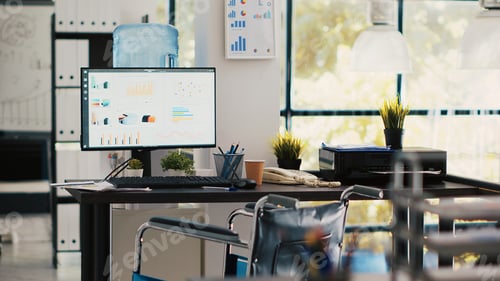 Preview: Wheelchair in inclusive office for workers and displays showing marketing charts