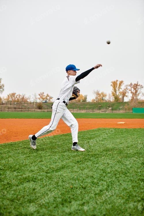 Preview: Talented teenage boy executes a perfect pitch on a vibrant baseball field