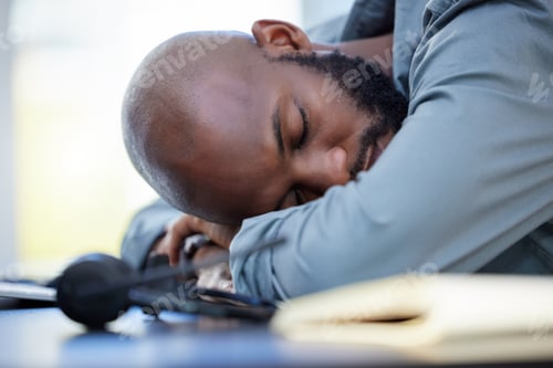 Preview: Burnout is real. Shot of a young businessman sleeping in an office at work.